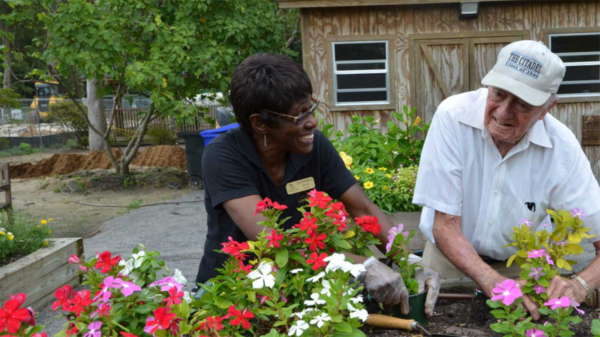 Elderly man working in harden with BG Connections care provider