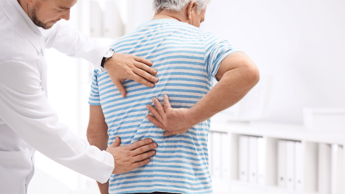 A chiropractor examines a patient