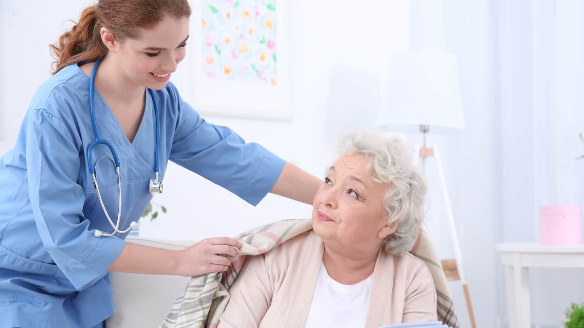 An elderly woman recives and a caring homecare professional