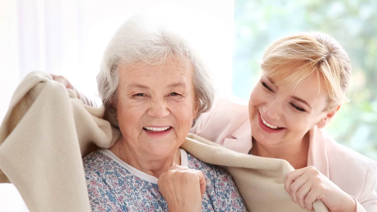 A happy elderly woman enjoys in home care