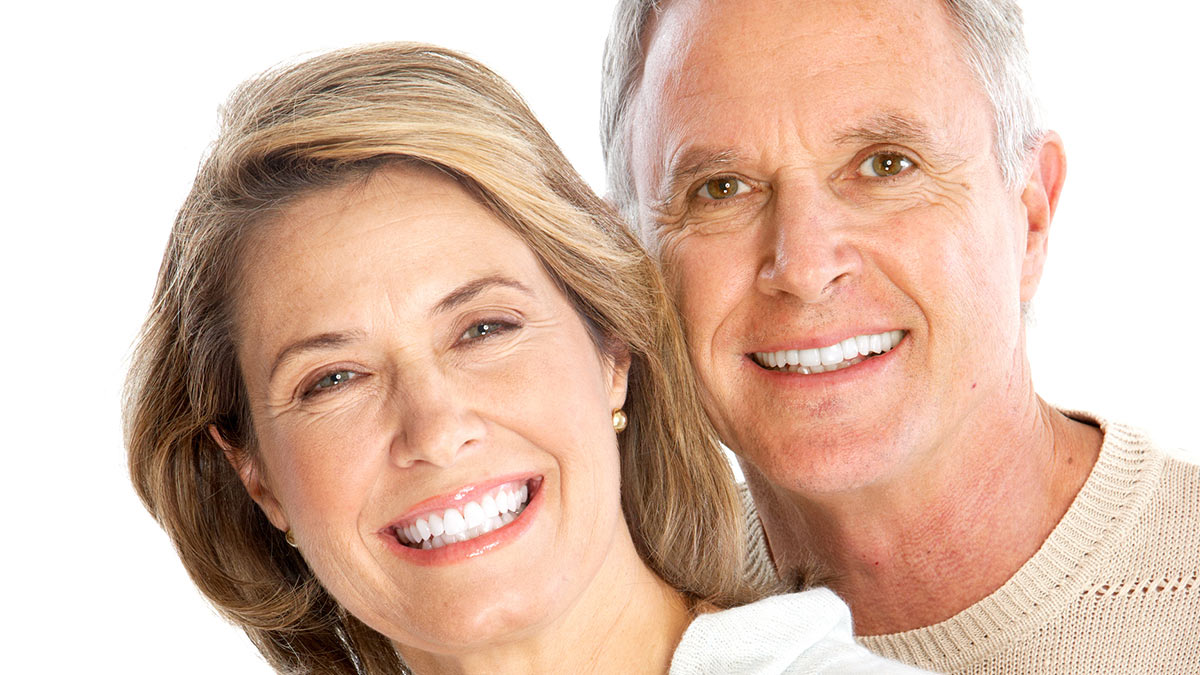 An older couple smiling & happy