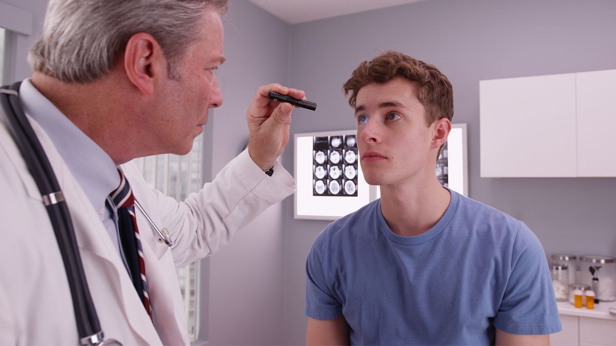 A young man getting checked over by hs doctor