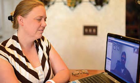 Wendy, an Air Force veteran, talks on the screen with mental health social worker Mark Murphy, LISW-CP. Photo by James Arrowood.
