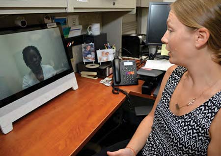 Anna Birks, PsyD, director of the Charleston Telemental Health Hub, uses telemedicine to talk with a veteran. Photo by James Arrowood.