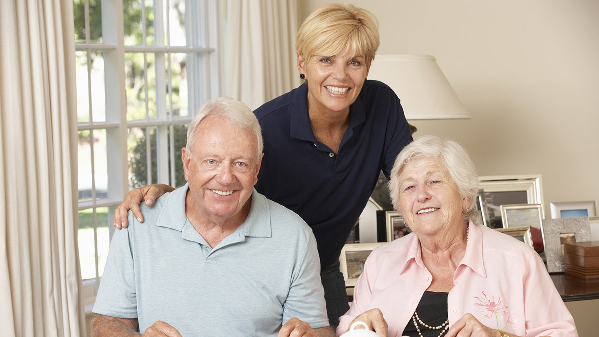 A Senior couple with a care provider.