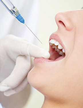 a woman recieves dental sedation by injection