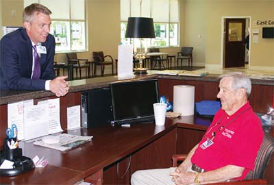 East Cooper Medical Center CEO Patrick Downes, left, talks with hospital volunteer Tom Fowler.