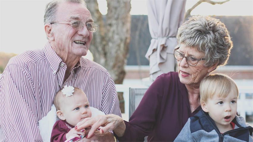 Preserving precious memories. An elderly couple with their grandchildren.