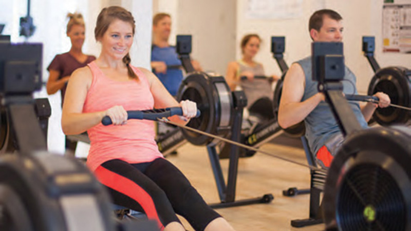 Mount Pleasant woman using a rowing machine for a full body workout