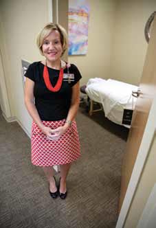 Wellness Navigator Jody McCrain stands in front of the massage room in the newly opened Donna Fielding Cancer Wellness Institute at Roper St. Francis