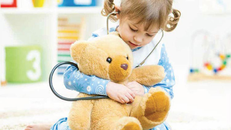 a girl playing with her teddy bear. Keeping our Kids healthy