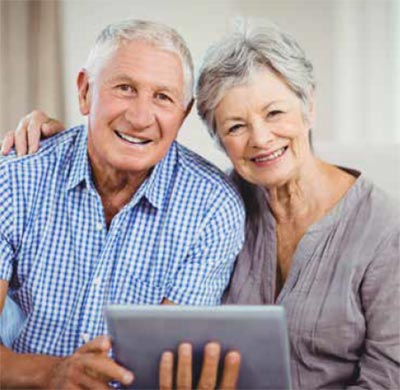 Preserving precious memories: an elderly couple with a computer tablet