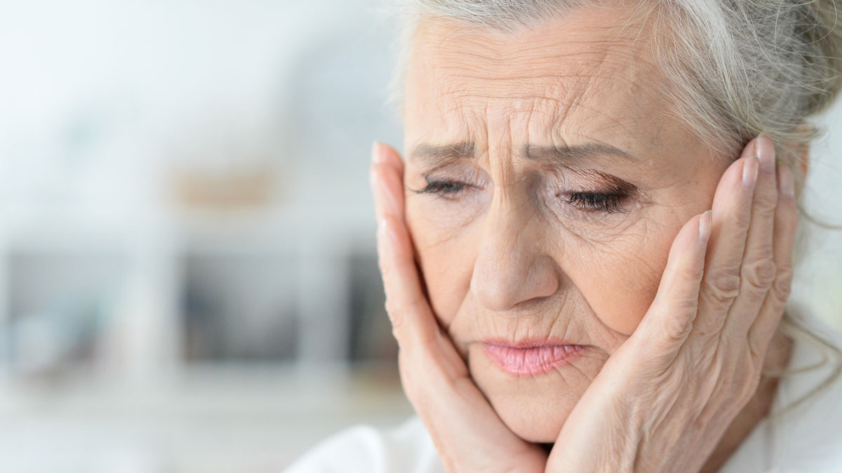 An upset elderly woman pained by her situation