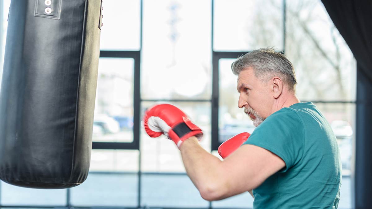 An older man following an exercise routine to keep mind and body sharp.