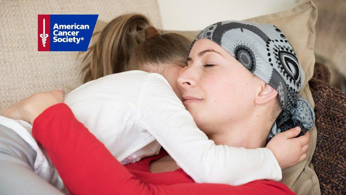 Woman hugging little girl, cancer patient, American Cancer Society