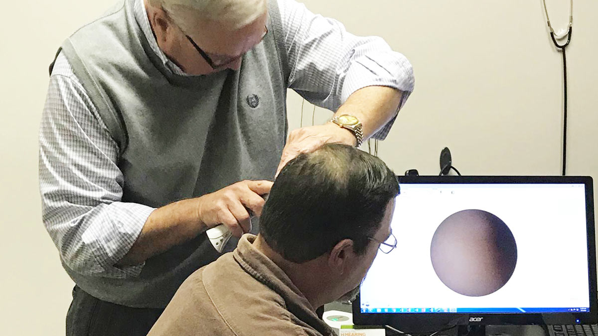 A patient gets a hearing evaluation for hearing aids.