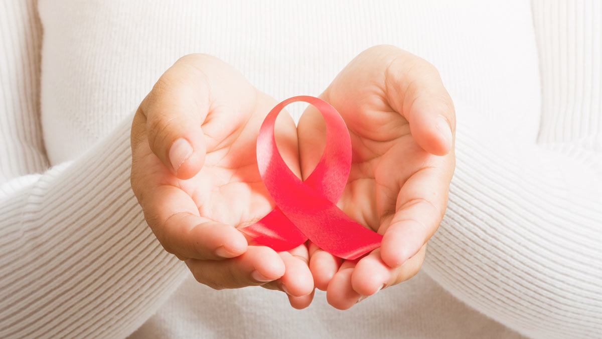 Breast cancer ribbon in a woman's hands