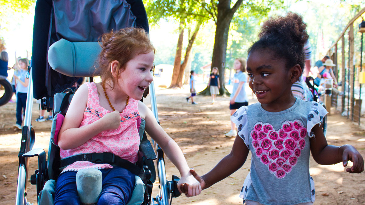 Two students at the South Carolina School for the Deaf and the Blind smile as they enjoy an afternoon outside.