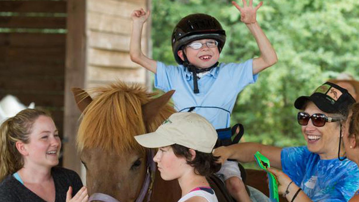 Photo for Resources for Disabled Children and Adults article. A young boy on a horse at Horse ‘N’ Around in Lancaster, SC.