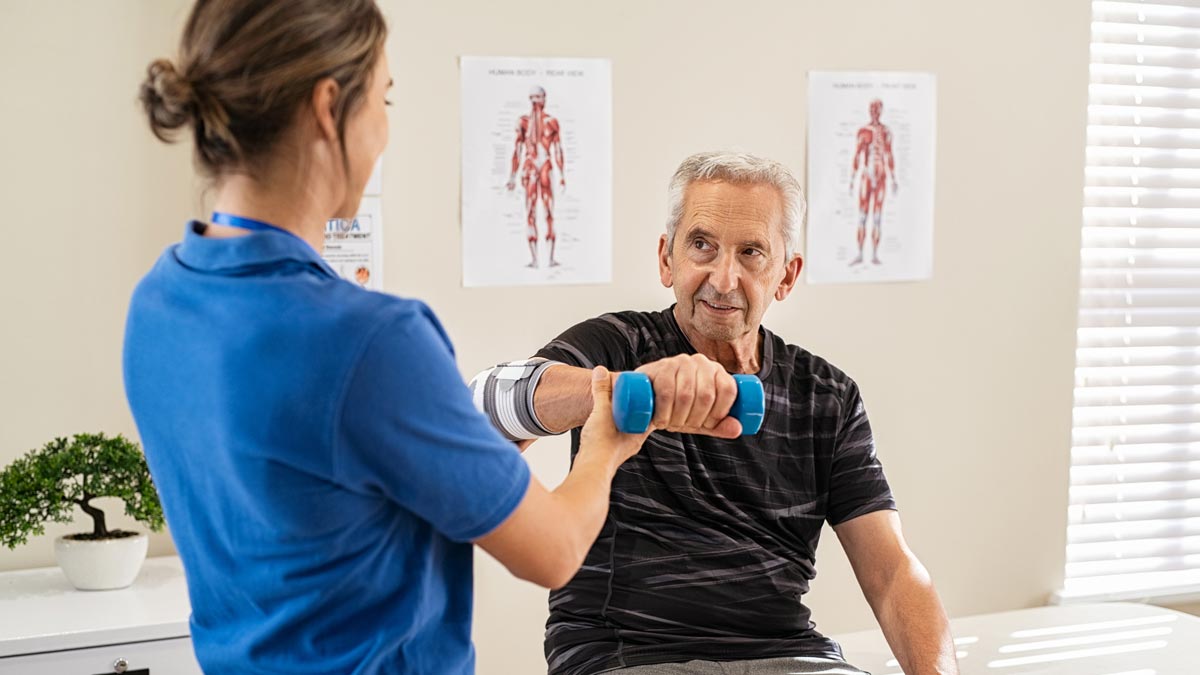 Photo: A Physical Therapist doing arm exercises in rehab with a patient.