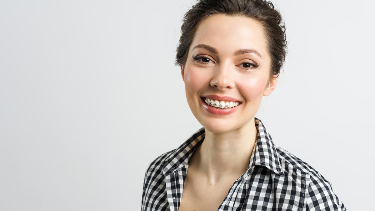 A woman with braces smiling.