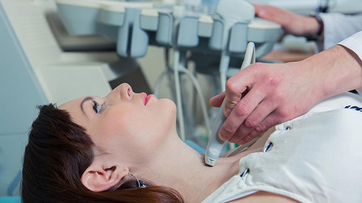 A woman getting an ultrasound on her neck