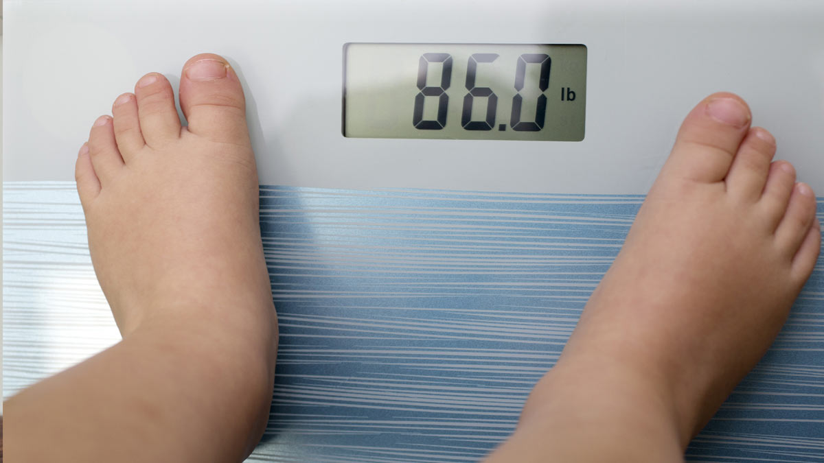 An overweight child getting weighed. "CCMS – Fighting Childhood Obesity" article.