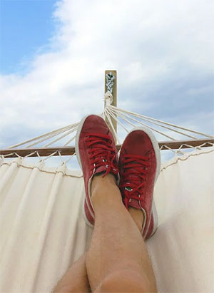 Relaxing under a calm sky on a hammock. Photo by Mateusz Dach on Pexels.com.