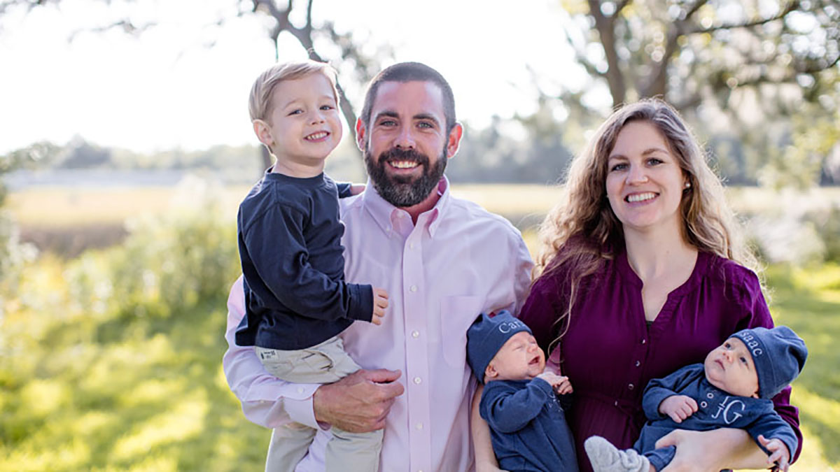 Photo of a woman and man with three young children