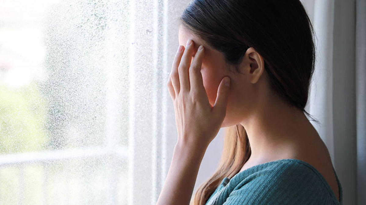 Photo of a woman looking out the window