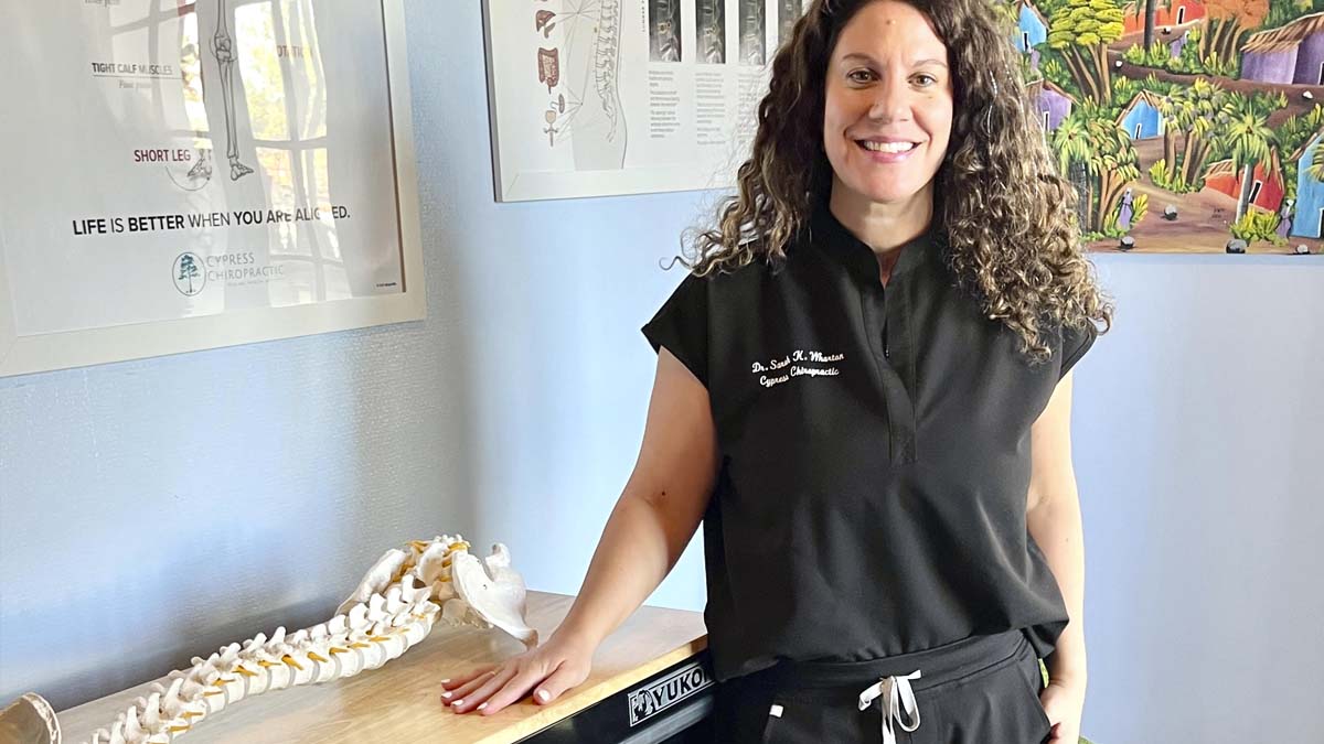 Photo of woman in scrubs in an office