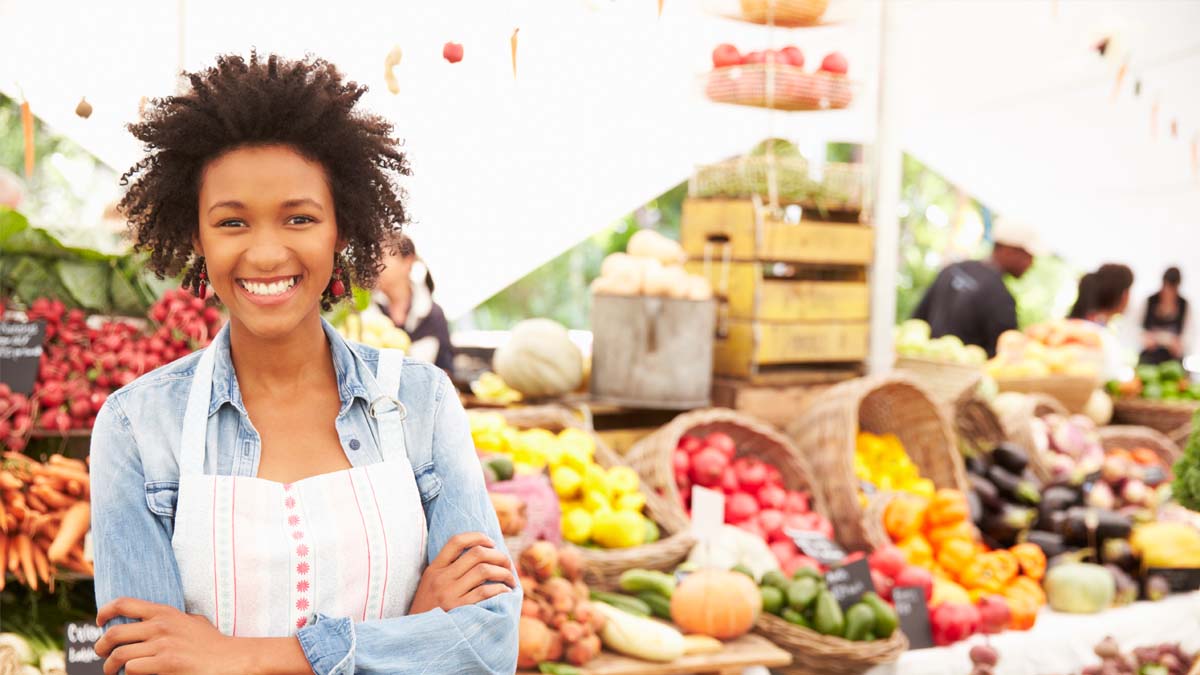 Photo of a woman in front of produce