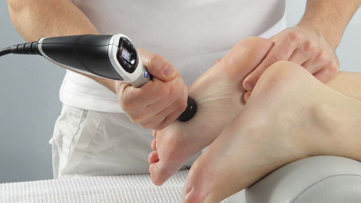 Photo of a foot getting shockwave therapy