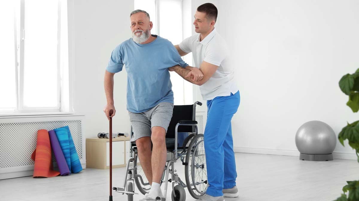 Photo of a man who has a cane with a nurse