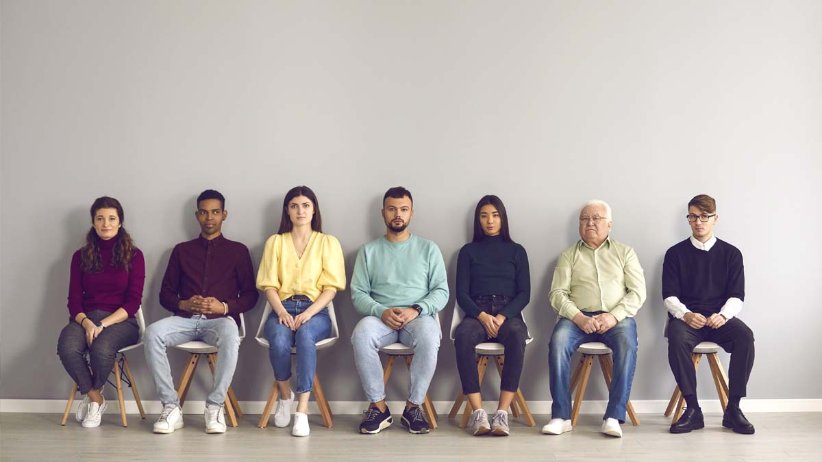 Photo of men and women sitting in chairs