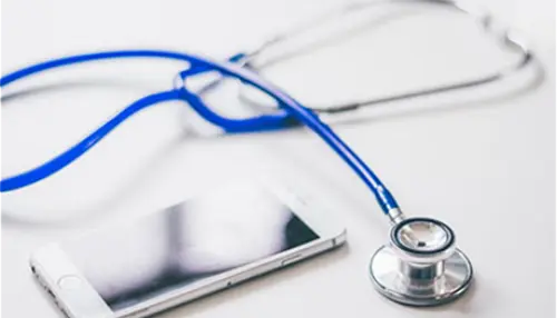 Photo of a stethoscope and a computer tablet.