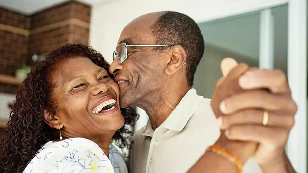 A mature couple dancing at home. Photo courtesy of Holy City Hearing.