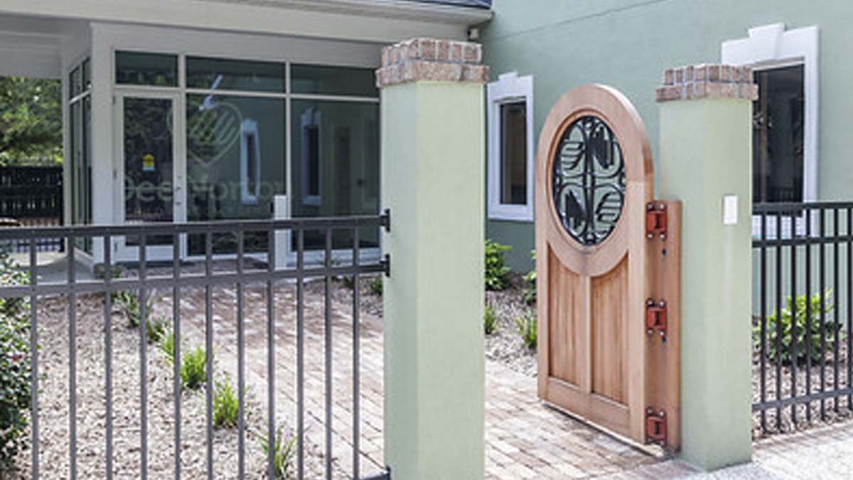 Photo of the front of a building with an open gate