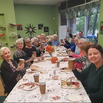 A group at Alice's Clubhouse raises their glasses in a toast. Cheers!