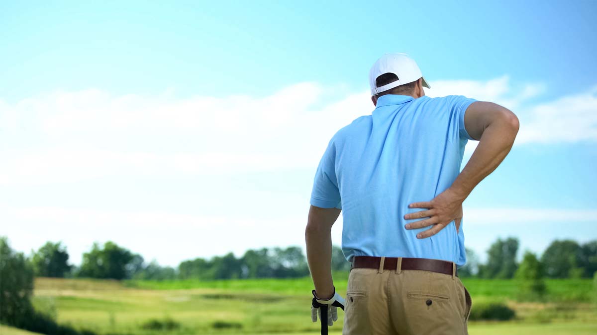 Photo of a man who is holding his lower back