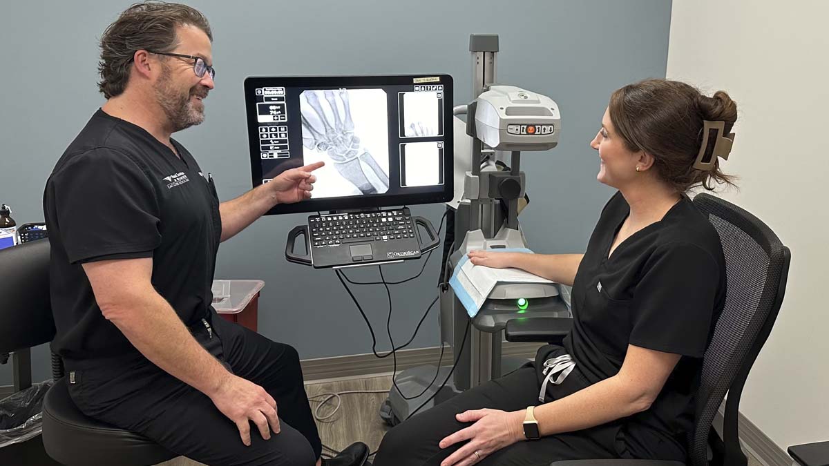 Photo of doctors looking at an x-ray of a hand