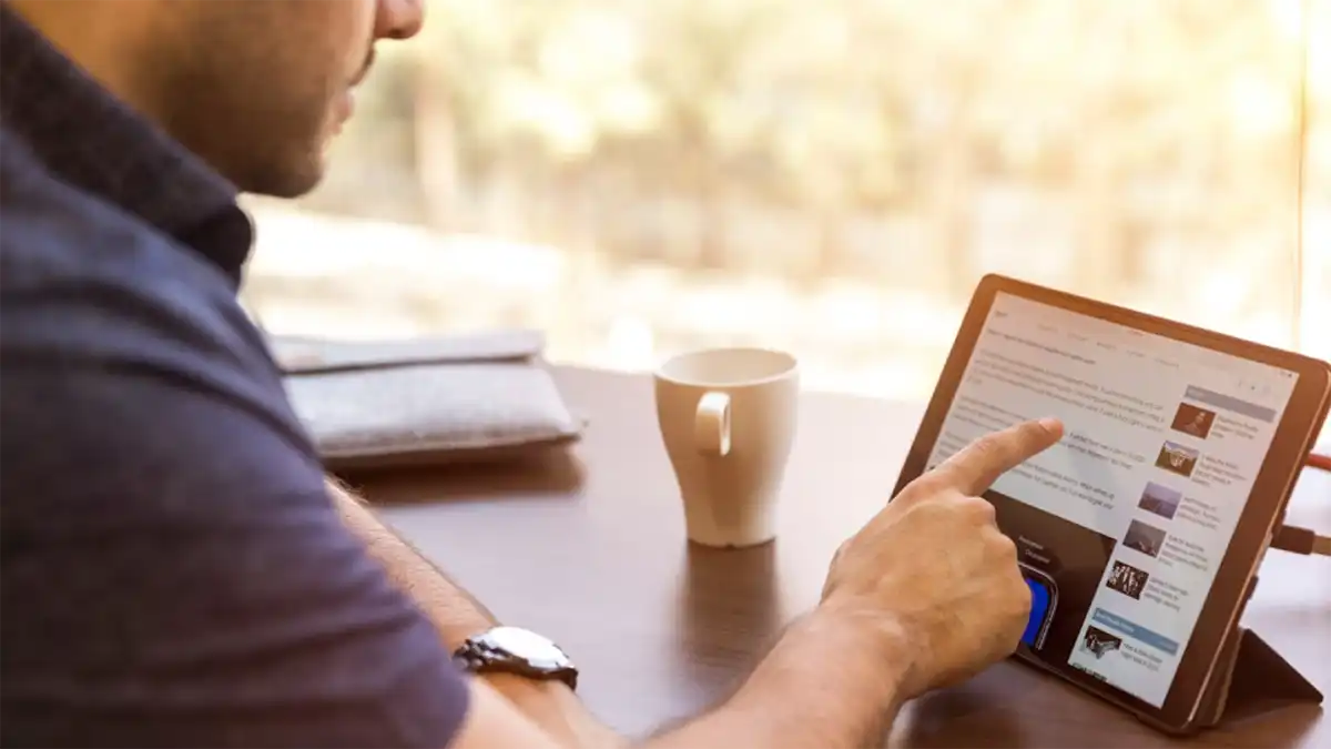 A man scrolling and reading a website.