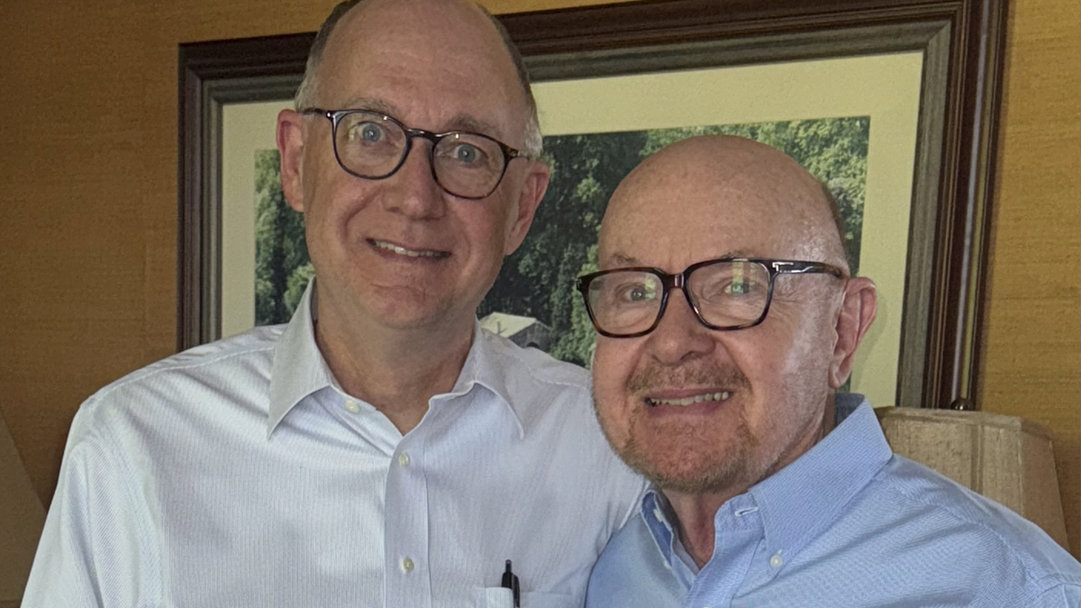 Photo of two men who are smiling