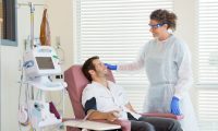 Photo of a doctor and a patient in a chair