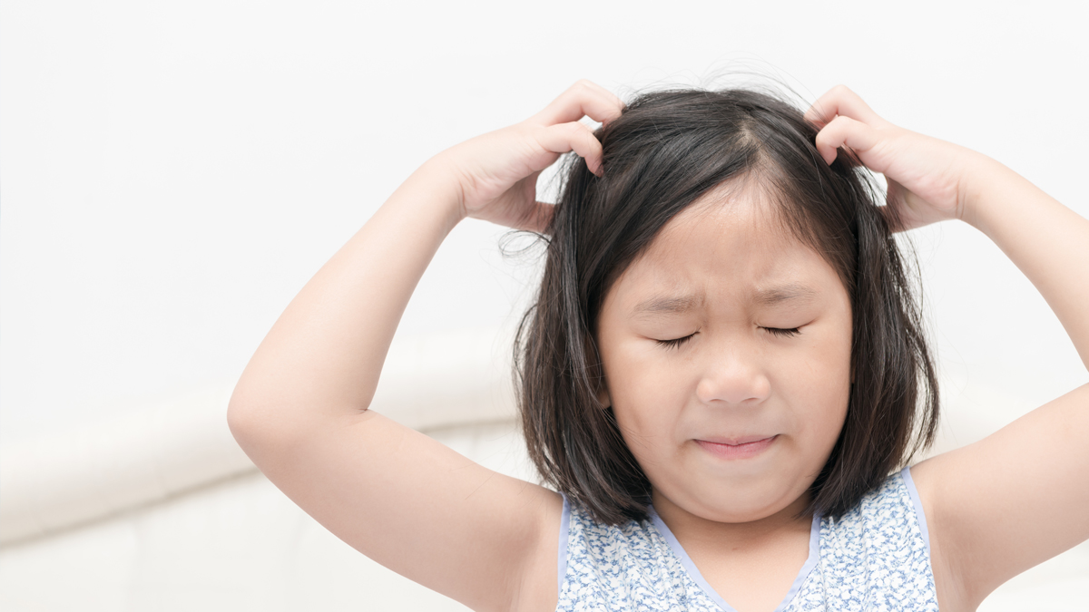 Photo of a child with her hands in her hair