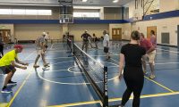 Photo of people playing pickleball on a court