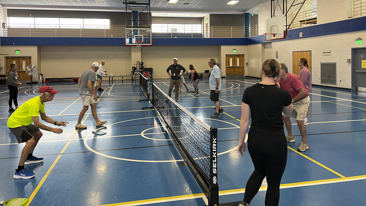 Photo of people playing pickleball on a court