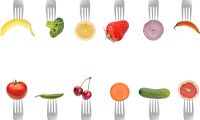 A photo of different kinds of food on forks