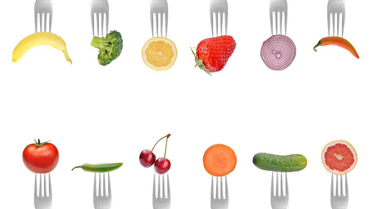 A photo of different kinds of food on forks