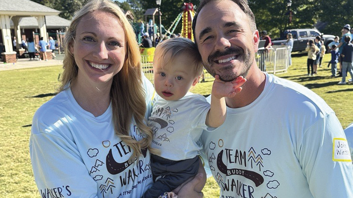 Photo of a man and woman holding a child